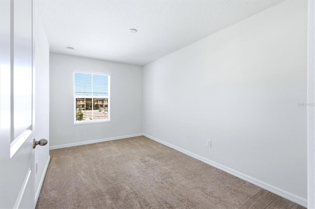12909 Dream Catcher Way Riverview, FL 33579 - Photo 21 of 32 a view of an empty room with a window