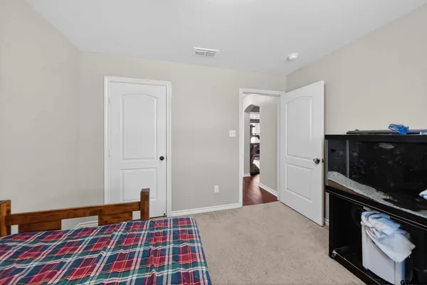 a bedroom with a bed and a chandelier