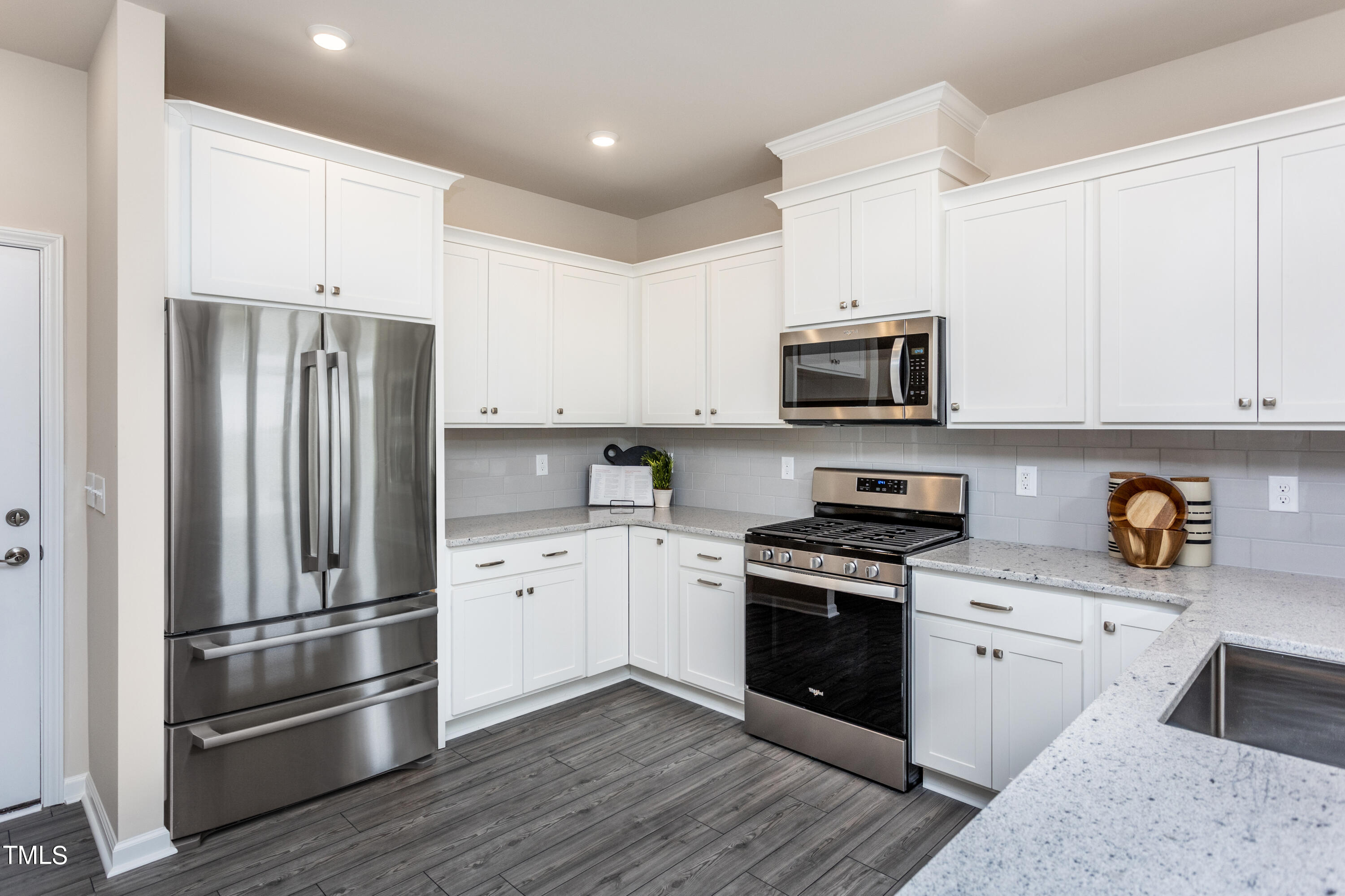 5603 Edessa Avenue Raleigh, NC 27603 - Photo 7 of 21 a kitchen with stainless steel appliances and white cabinets