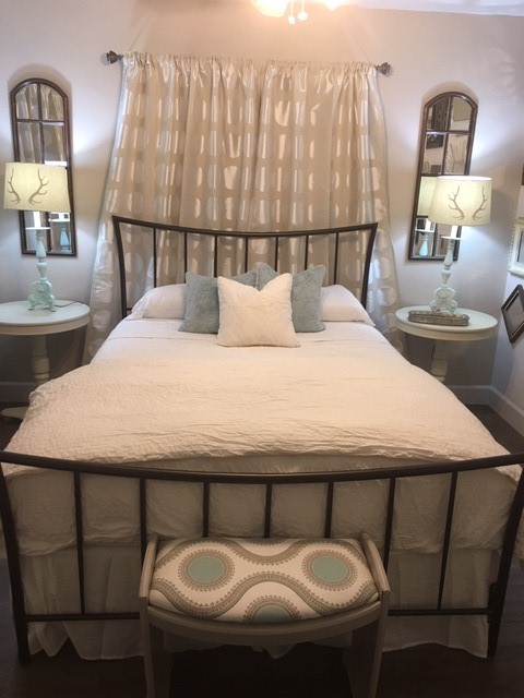 a bedroom with a table chairs and a bed