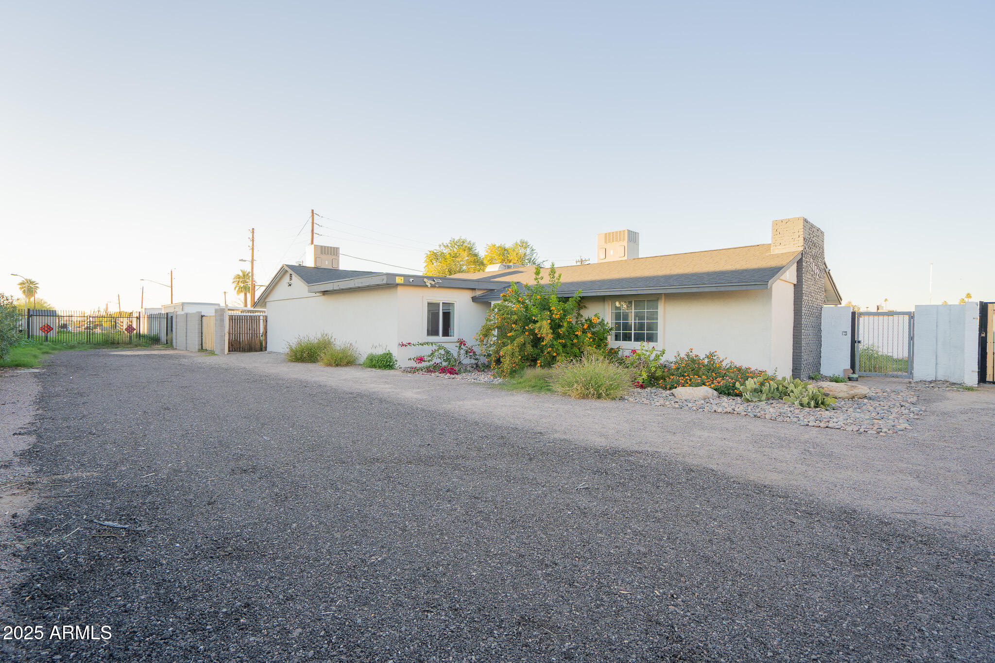 a view of a house with a big yard and large trees