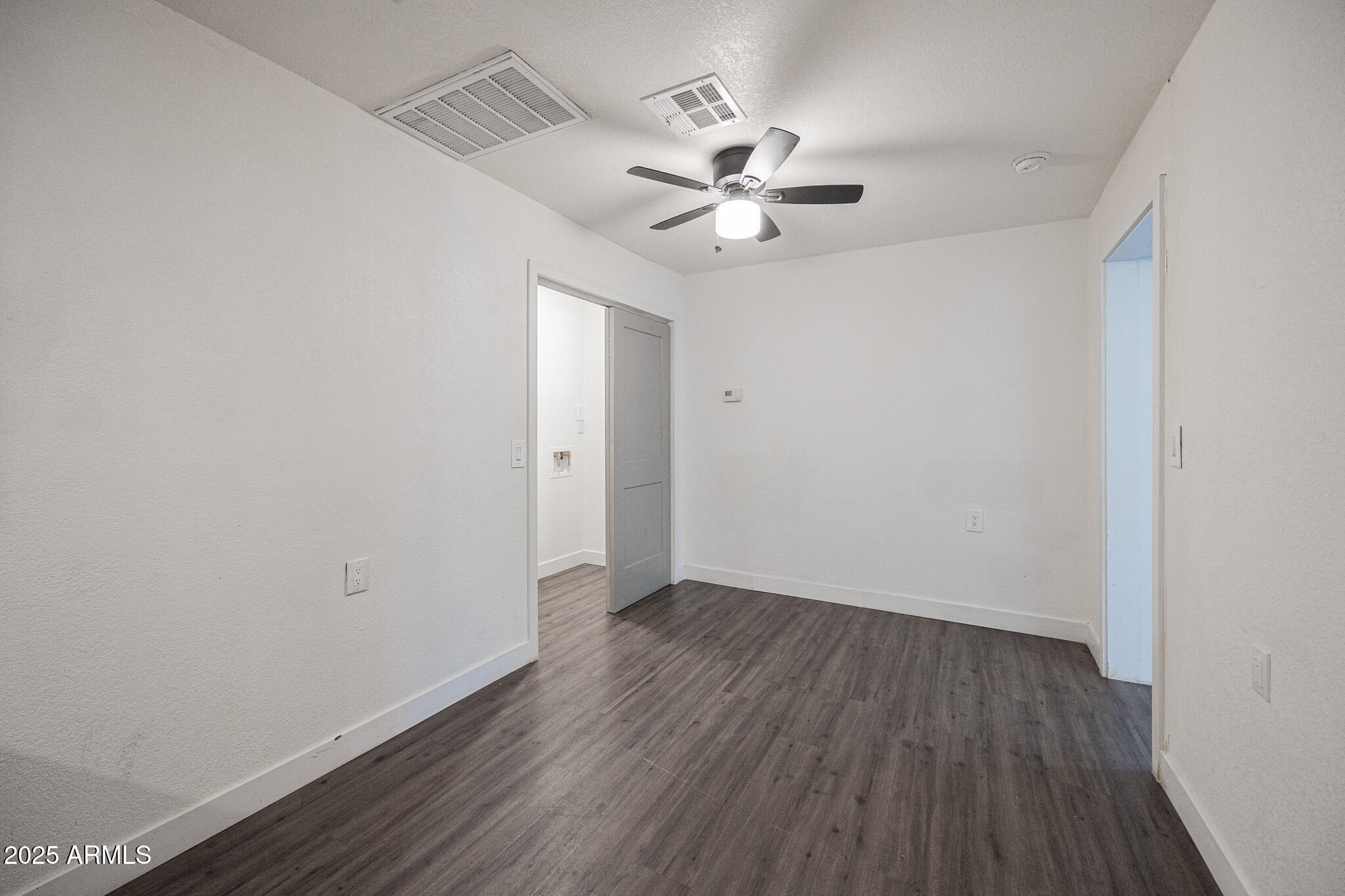 2802 North 36th Street, Unit 3 Phoenix, AZ 85008 - Photo 11 of 23 a view of an empty room with wooden floor