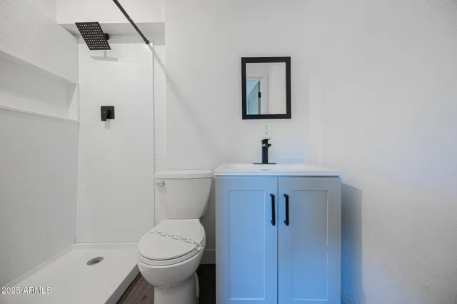 a bathroom with a toilet sink and shower
