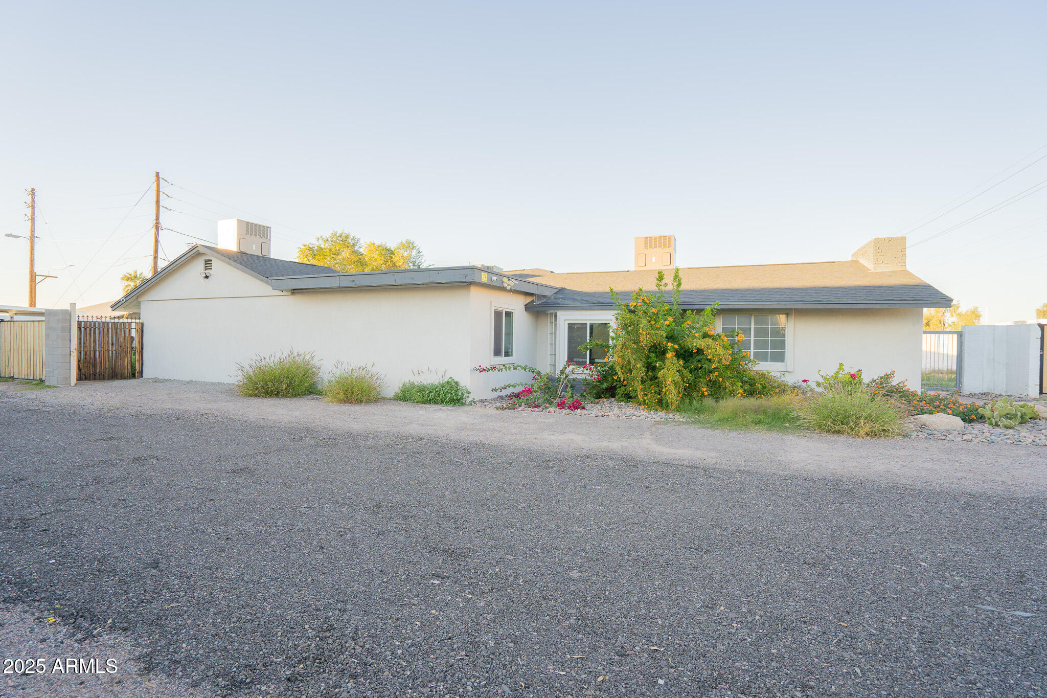 2802 North 36th Street, Unit 3 Phoenix, AZ 85008 - Photo 5 of 23 a front view of a house with a yard and a garage