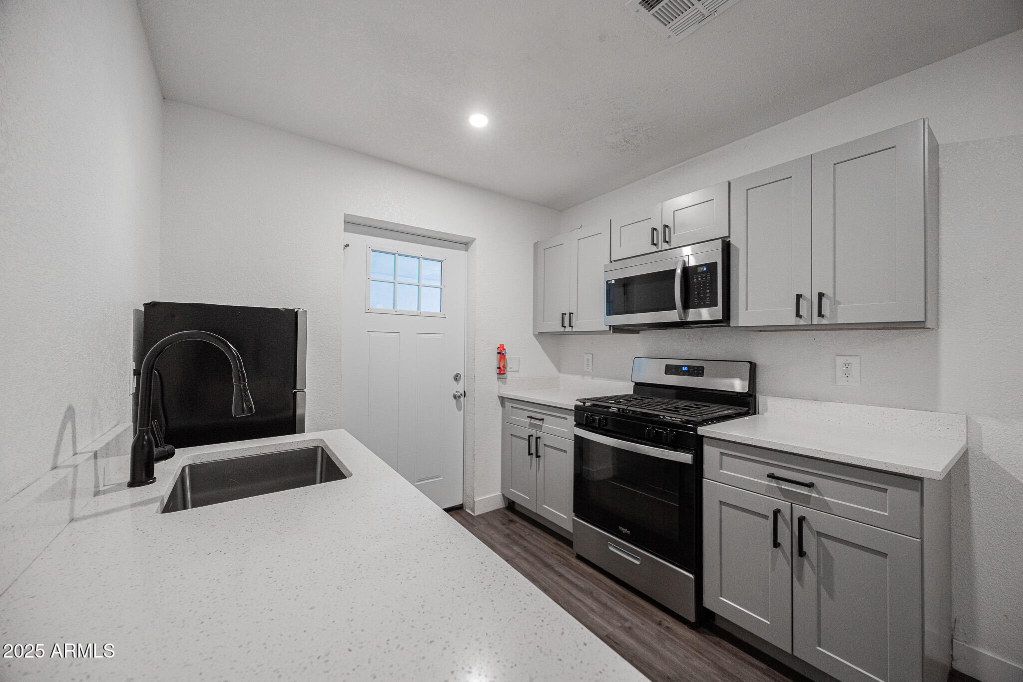 2802 North 36th Street, Unit 3 Phoenix, AZ 85008 - Photo 7 of 23 a kitchen with sink a microwave and stove
