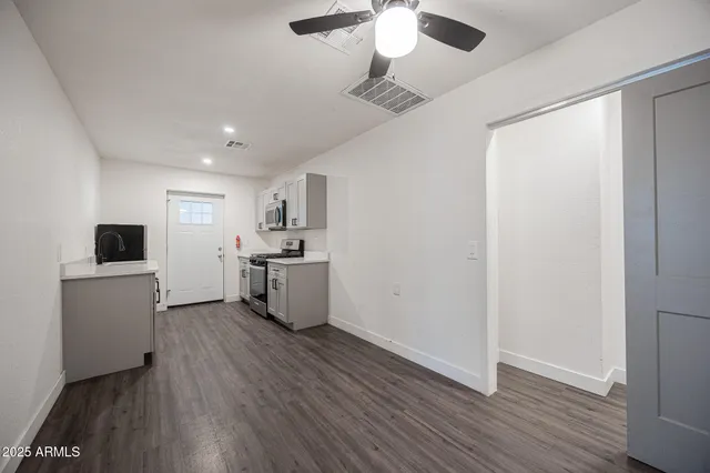 a kitchen with a refrigerator and a stove top oven