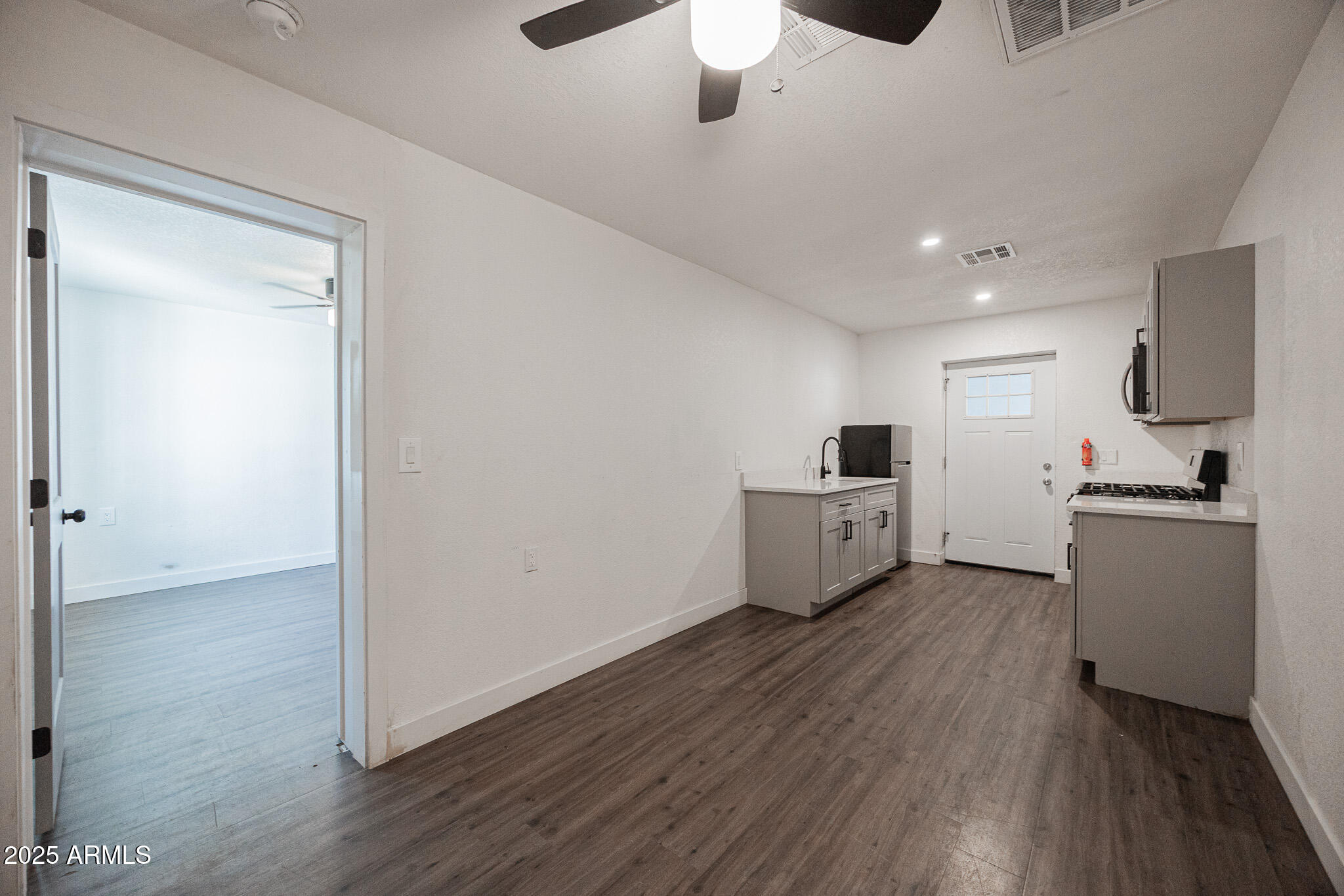 2802 North 36th Street, Unit 3 Phoenix, AZ 85008 - Photo 10 of 23 a view of a kitchen with wooden floor and a sink