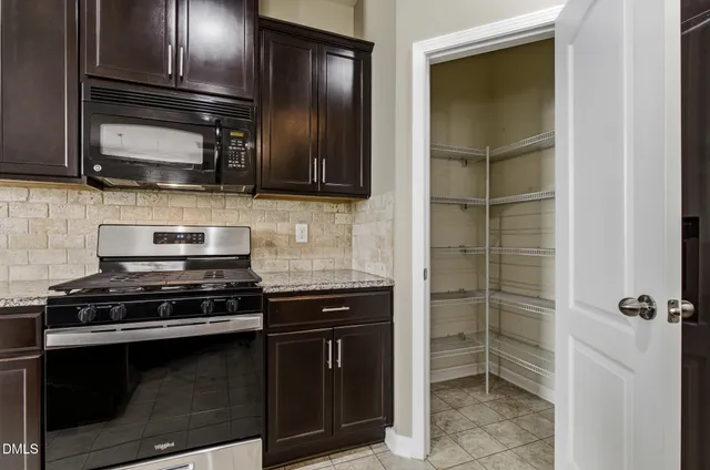 a kitchen with stainless steel appliances and cabinets