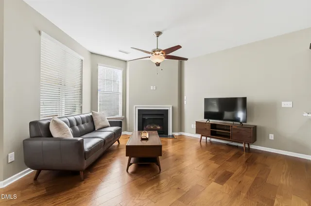 a living room with furniture flat screen tv and a fireplace