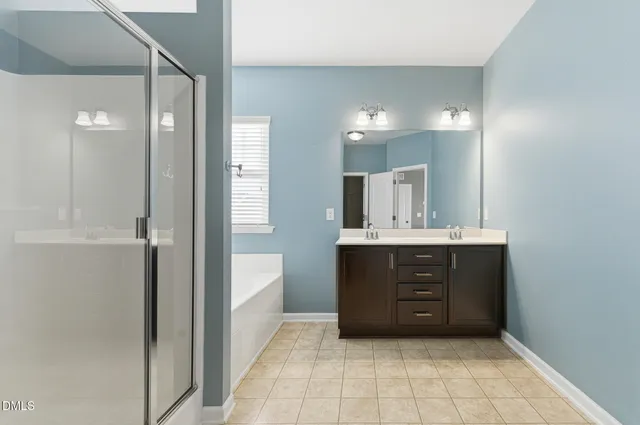 a bathroom with a sink vanity and a mirror