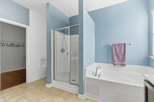 a bathroom with a bathtub and a shower