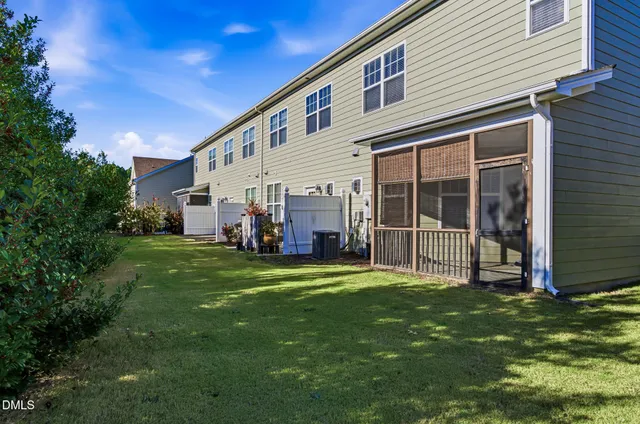 a view of a house with a yard and deck