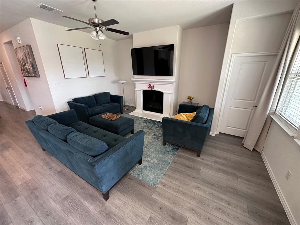 1016 Sublime Drive Forney, TX 75126 - Photo 4 of 15 a living room with furniture a flat screen tv and a fireplace