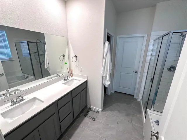 a bathroom with a double vanity sink and mirror