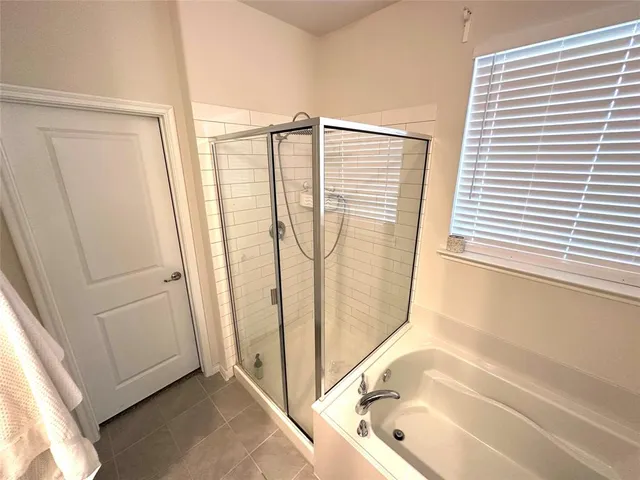 a bathroom with a bathtub and a shower