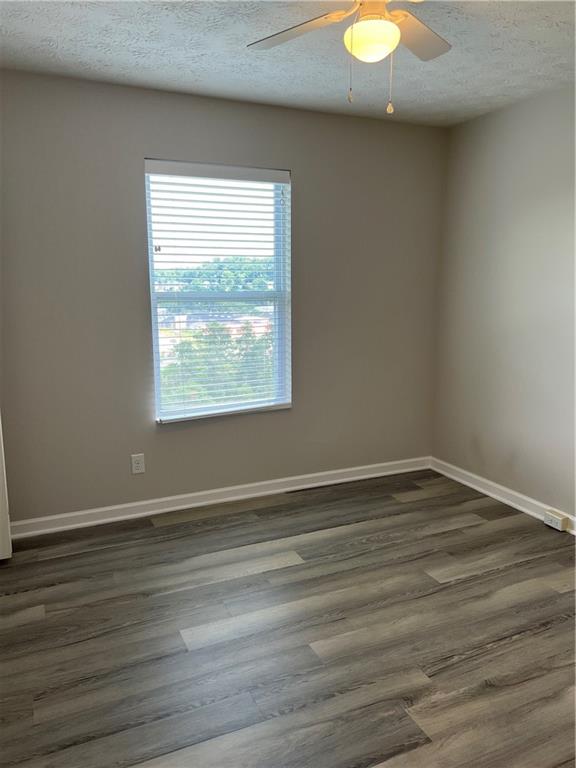 102 Alderwood Drive Greensburg, PA 15601 - Photo 11 of 12 an empty room with wooden floor and windows
