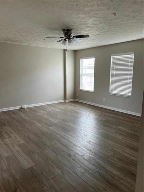 102 Alderwood Drive Greensburg, PA 15601 - Photo 3 of 12 an empty room with wooden floor ceiling fan and windows