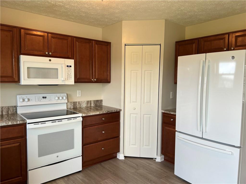102 Alderwood Drive Greensburg, PA 15601 - Photo 7 of 12 a kitchen with a cabinets and a stove top oven