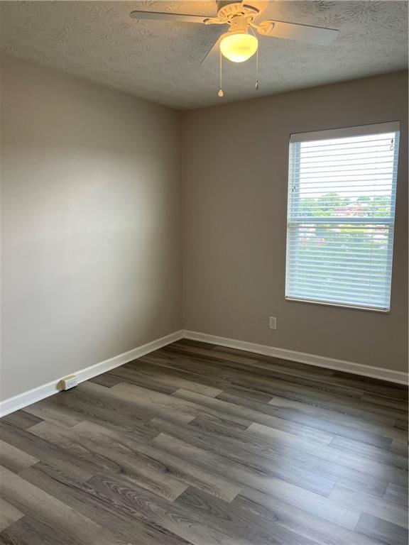 102 Alderwood Drive Greensburg, PA 15601 - Photo 10 of 12 an empty room with wooden floor and windows