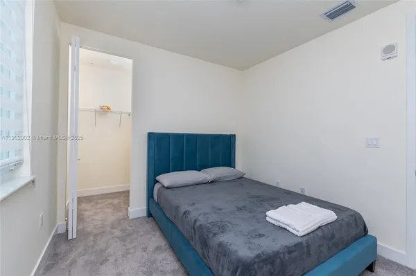 a bedroom with a bed and window
