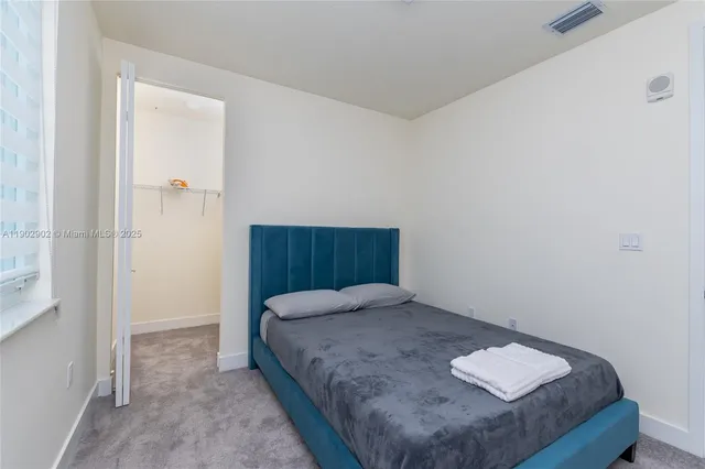 a bedroom with a bed and window