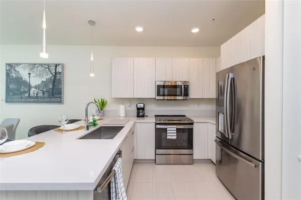 a kitchen that has a sink and a stove in it