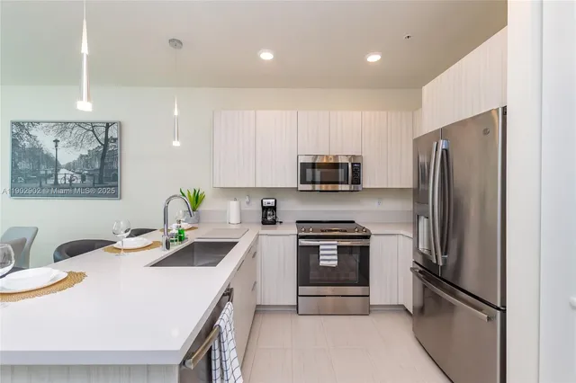 a kitchen that has a sink and a stove in it