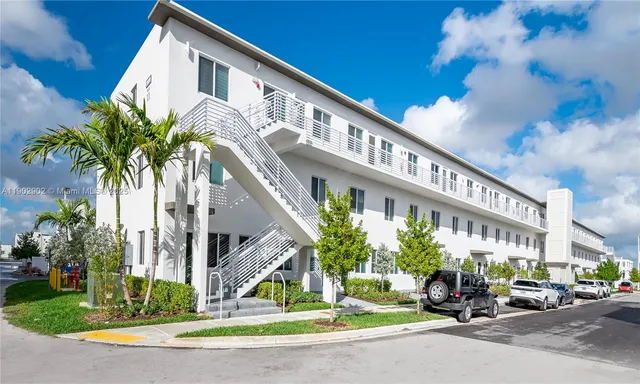 a view of a building with a small yard