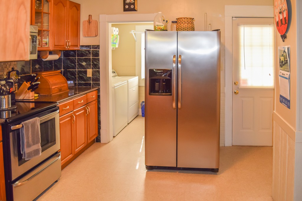 18 Claremont Street Springfield, MA 01108 - Photo 4 of 13 a kitchen with stainless steel appliances a refrigerator and a stove