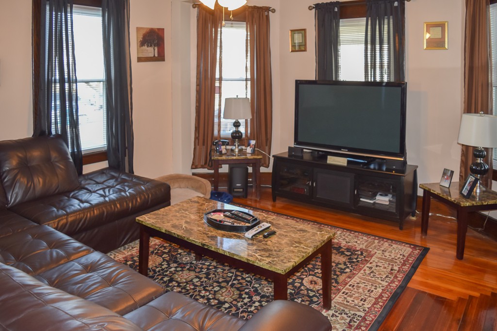 18 Claremont Street Springfield, MA 01108 - Photo 10 of 13 a living room with furniture and a flat screen tv