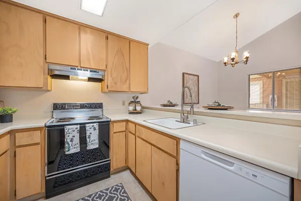 a kitchen with a sink stove and cabinets