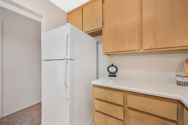 a close view of a refrigerator and cabinets