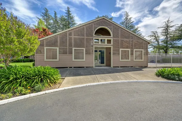 a view of backyard with swimming pool and seating space
