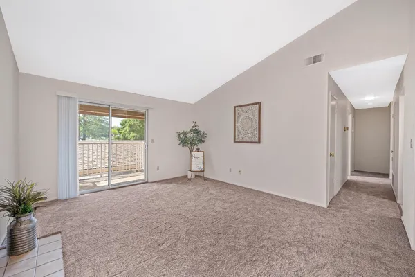 an empty room with windows and closet
