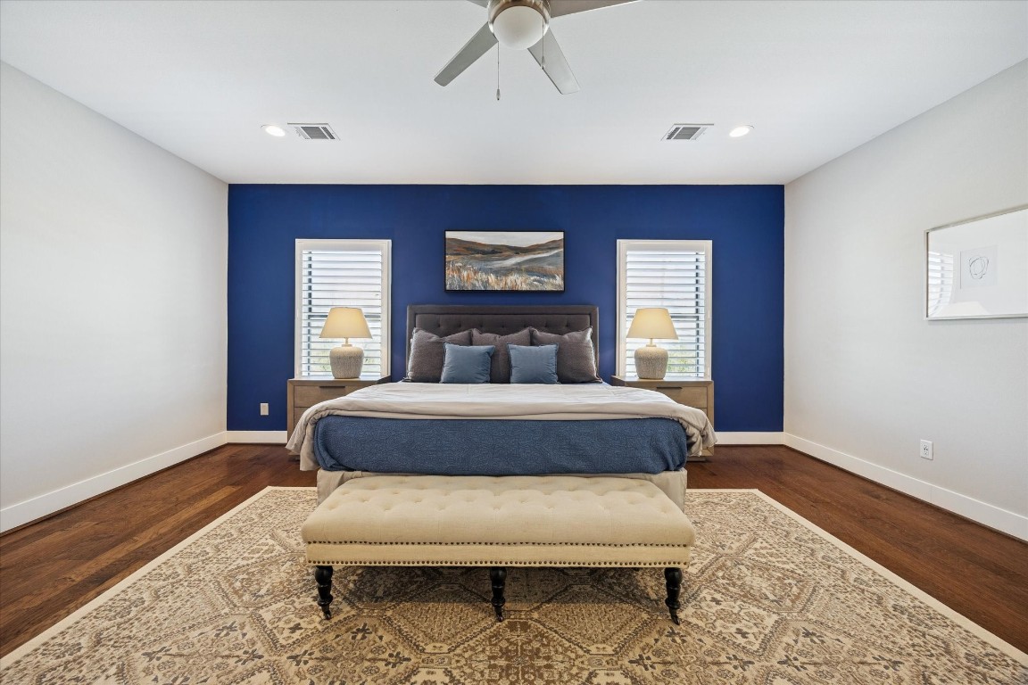 920 West 25th Street, Unit B Houston, TX 77008 - Photo 17 of 35 a bedroom with a bed window and wooden floor