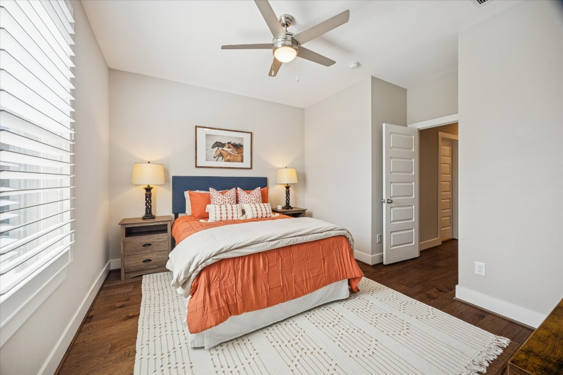 920 West 25th Street, Unit B Houston, TX 77008 - Photo 26 of 35 a bedroom with a bed and a walk in closet with wooden floor