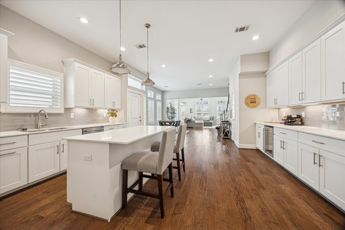 920 West 25th Street, Unit B Houston, TX 77008 - Photo 7 of 35 a large white kitchen with lots of counter space dining table and chairs