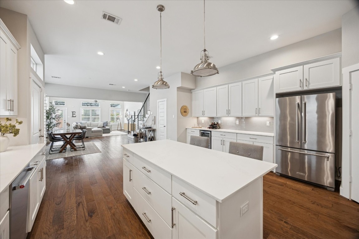 920 West 25th Street, Unit B Houston, TX 77008 - Photo 34 of 35 a large white kitchen with lots of counter space wooden floor and appliances