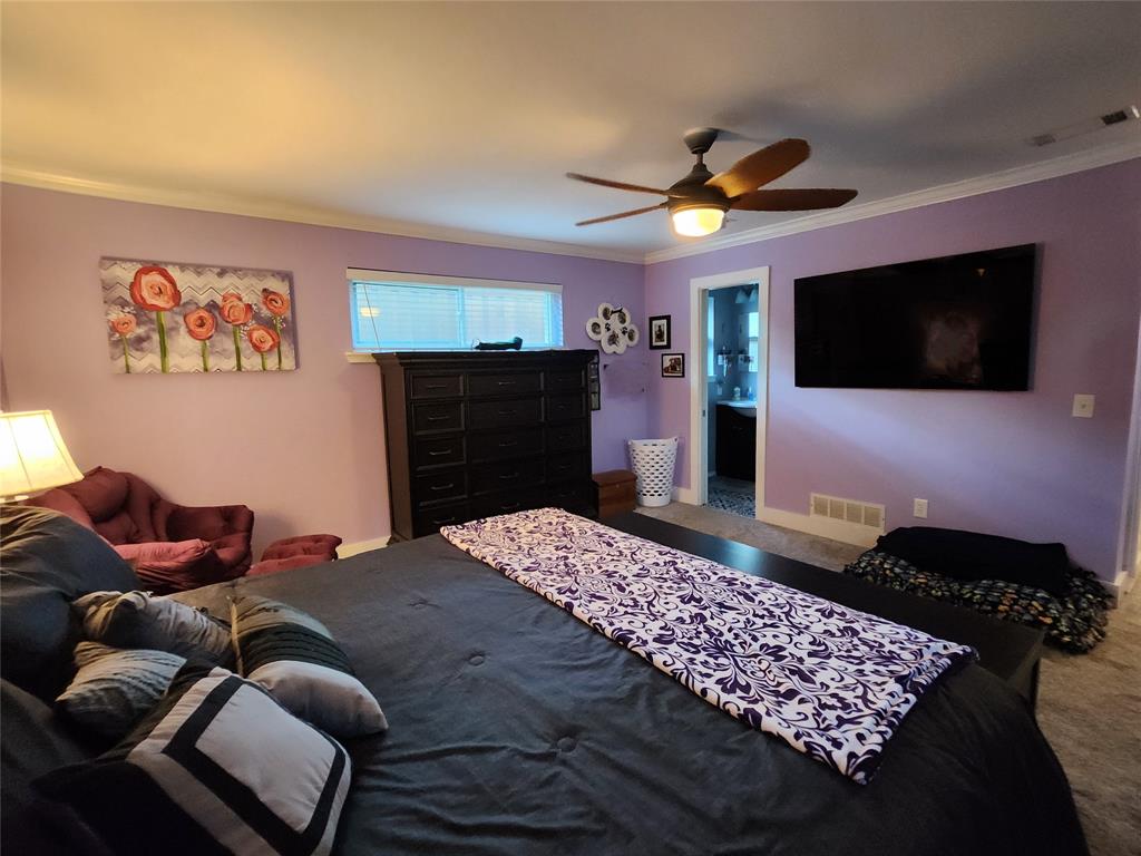 1023 Ridgefield Drive Plano, TX 75075 - Photo 28 of 39 a bedroom with a bed and a flat screen tv