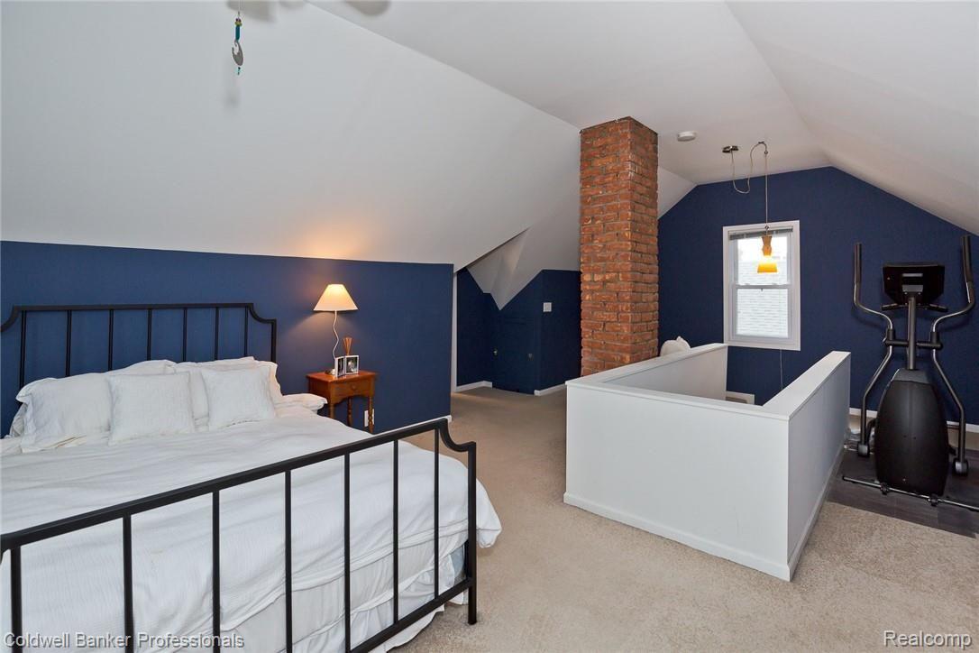1059 Harvard Road Berkley, MI 48072 - Photo 14 of 20 2nd floor Master Bedroom is spacious and features a ceiling fan/light, exposed brick, and walk-in closet.