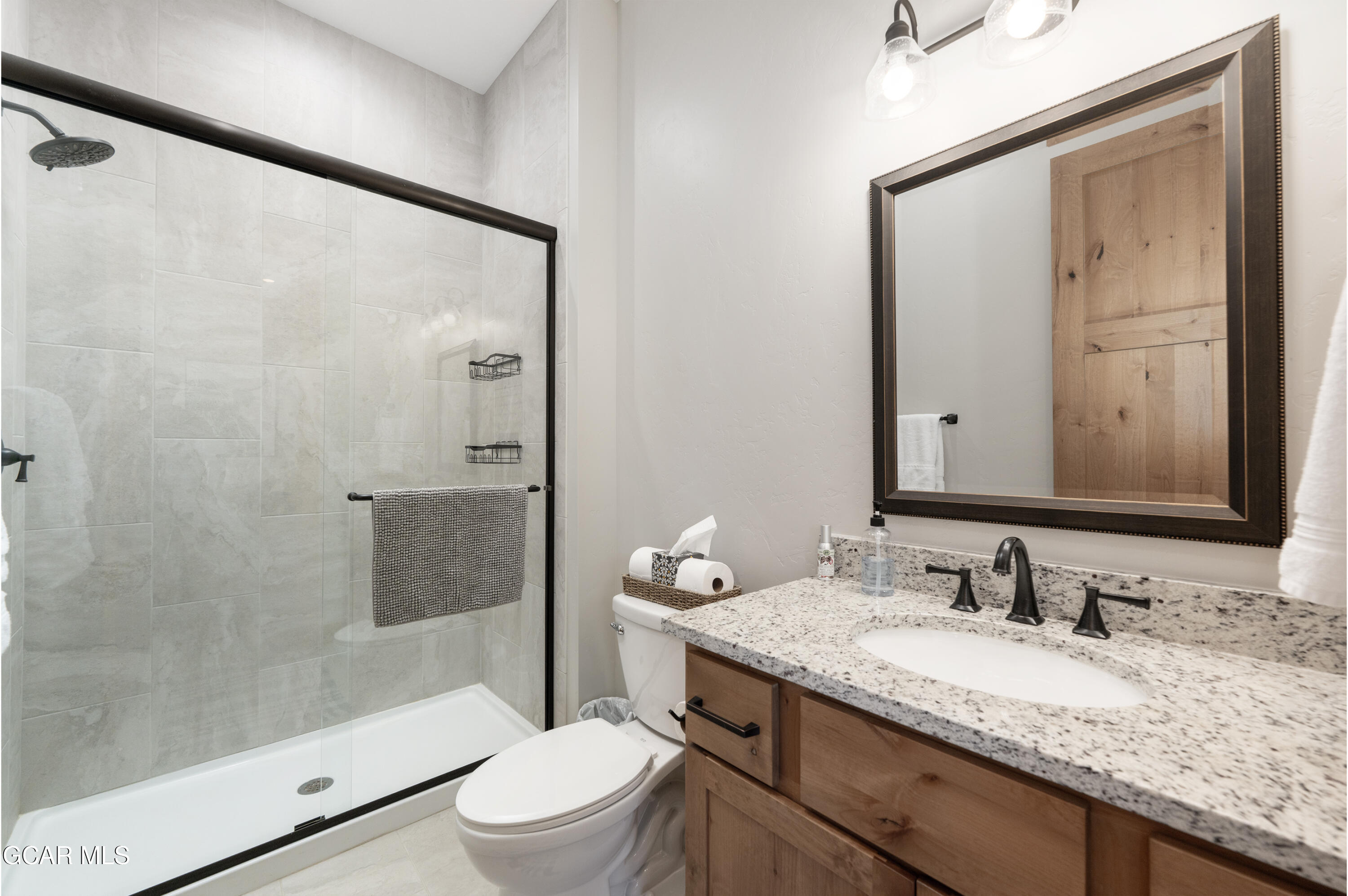 16 Springview Lane Fraser, CO 80442 - Photo 24 of 36 a bathroom with a granite countertop sink toilet and shower