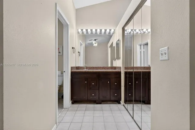 a bathroom with a sink a mirror and a shower