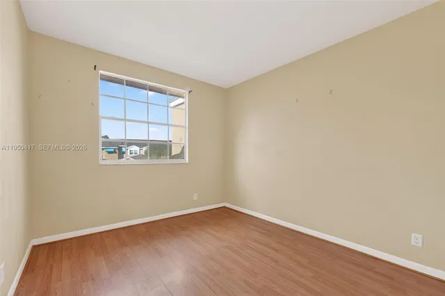 a view of a room with wooden floor and windows