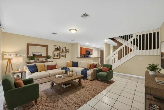 a living room with furniture and a floor to ceiling window