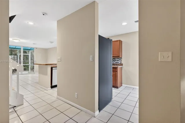 a view of kitchen with furniture and refrigerator