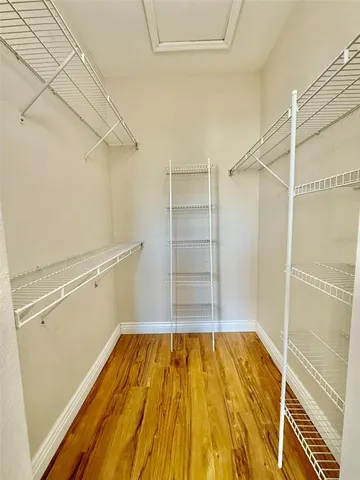 a view of a room with wooden floor and cabinet