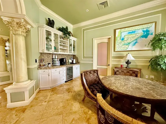 a living room with stainless steel appliances kitchen island granite countertop furniture and a fireplace
