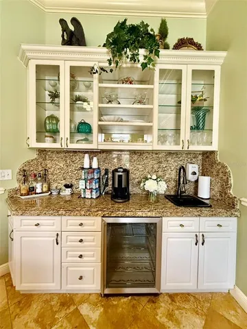 a kitchen with granite countertop a sink and a stove