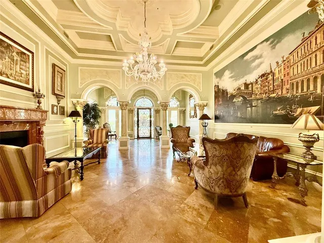 a living room with fireplace furniture and a rug