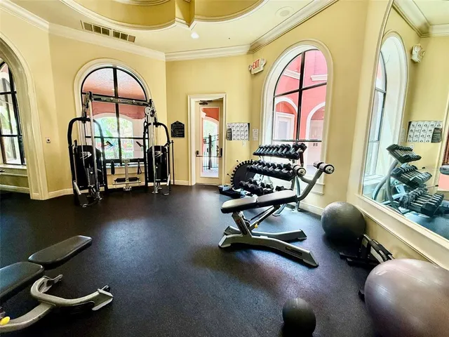 a room with gym equipment and large mirror
